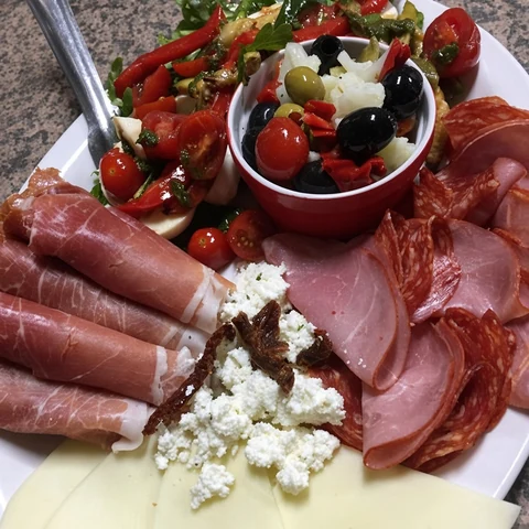 Antipasti platter with cured meats, olives and vegetables