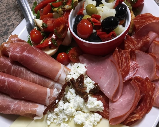 Antipasti platter with cured meats, olives and vegetables